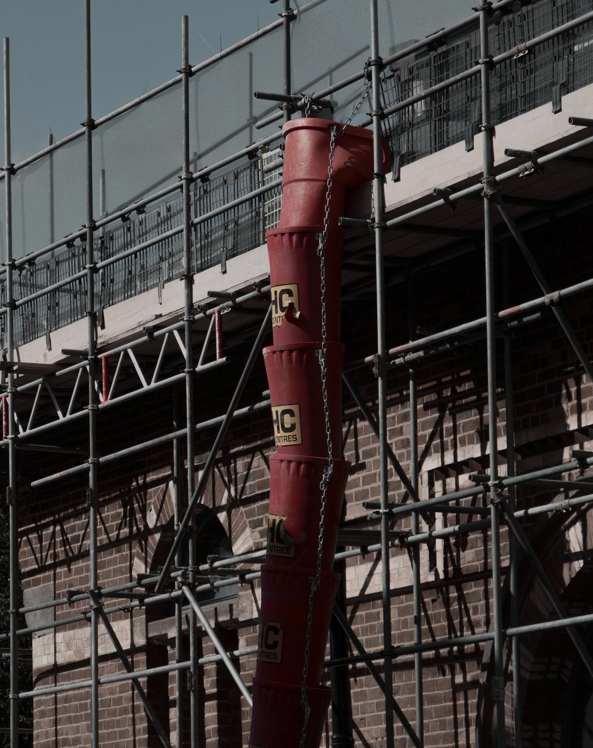 Self-made chute for concreting works. Concrete pours down a wooden